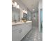 Stylish bathroom featuring dual sinks, decorative tile flooring, and modern fixtures at 5105 68Th N Way, St Petersburg, FL 33709