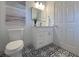Stylish bathroom with a decorative floor, modern vanity, and elegant mirror at 5105 68Th N Way, St Petersburg, FL 33709