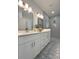 Stylish bathroom featuring dual sinks, decorative tile flooring, and modern fixtures at 5105 68Th N Way, St Petersburg, FL 33709
