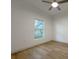 Sunlit bedroom with wood-look floors, a ceiling fan, and a window view at 5105 68Th N Way, St Petersburg, FL 33709