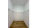 Walk-in closet with wire shelving and hardwood floors, providing ample storage space at 5105 68Th N Way, St Petersburg, FL 33709