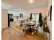 Open-concept dining area featuring an adjacent kitchen, wood-look floors, and a sliding glass door to the backyard at 5105 68Th N Way, St Petersburg, FL 33709