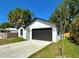 Charming single-story home featuring a wide driveway and a two-car garage at 5105 68Th N Way, St Petersburg, FL 33709