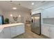 Modern kitchen with stainless steel appliances, white cabinets, and an open layout at 5105 68Th N Way, St Petersburg, FL 33709