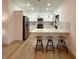 Modern kitchen featuring stainless steel appliances, white cabinetry, and a breakfast bar with seating at 5105 68Th N Way, St Petersburg, FL 33709