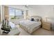 Bright main bedroom featuring a large window with ocean view and wicker furnishings at 5155 Isla Key S Blvd # 304, St Petersburg, FL 33715