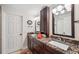 Bathroom with double sinks, granite countertops, and modern fixtures and lighting at 5240 Coquina Key Se Dr # B, St Petersburg, FL 33705
