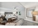 This bedroom features a king bed, a seating bench, neutral decor, and a large mirror at 5240 Coquina Key Se Dr # B, St Petersburg, FL 33705