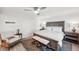 Well-lit bedroom featuring a wooden bed frame, ceiling fan, and cozy seating area at 5240 Coquina Key Se Dr # B, St Petersburg, FL 33705