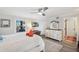 This bedroom features a ceiling fan, a queen bed, and a bright window with natural light at 5240 Coquina Key Se Dr # B, St Petersburg, FL 33705