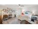 This bedroom features a ceiling fan, a queen bed, and a gallery wall with multiple pictures at 5240 Coquina Key Se Dr # B, St Petersburg, FL 33705