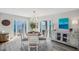 Bright dining room with ocean view, a round table for four, and a decorative chandelier at 5240 Coquina Key Se Dr # B, St Petersburg, FL 33705
