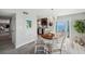 Dining area features a chandelier, seating for four, and access to the balcony at 5240 Coquina Key Se Dr # B, St Petersburg, FL 33705
