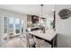 This modern kitchen features an island with seating and sliding doors to the balcony with a view at 5240 Coquina Key Se Dr # B, St Petersburg, FL 33705