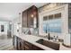 Modern kitchen features stylish cabinetry, countertops, and a stainless steel sink with ocean view at 5240 Coquina Key Se Dr # B, St Petersburg, FL 33705
