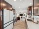 Open-concept kitchen featuring stainless steel appliances, granite counters, and a seamless flow to living spaces at 5240 Coquina Key Se Dr # B, St Petersburg, FL 33705
