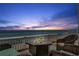 Waterfront patio view at sunset with outdoor firepit and comfortable wicker seating at 5240 Coquina Key Se Dr # B, St Petersburg, FL 33705