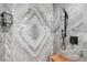 Walk-in shower featuring decorative stone tile, a rain shower head, and a built-in bench at 5240 Coquina Key Se Dr # B, St Petersburg, FL 33705