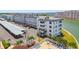 A white condo complex features a swimming pool and palm trees with water views at 5960 30Th S Ave # 414, Gulfport, FL 33707