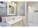 Stylish bathroom with patterned wallpaper, vanity, and updated fixtures at 5960 30Th S Ave # 414, Gulfport, FL 33707