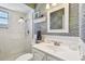 Stylish bathroom with patterned wallpaper, vanity, and glass-enclosed shower at 5960 30Th S Ave # 414, Gulfport, FL 33707