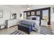 Comfortable bedroom with accent wall, ceiling fan, stylish furnishings, and neutral flooring at 5960 30Th S Ave # 414, Gulfport, FL 33707