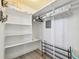 Walk-in closet offering ample storage with shelving and hanging space at 5960 30Th S Ave # 414, Gulfport, FL 33707