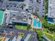 Aerial view of the community pool with lounge chairs, umbrellas, and surrounding green spaces at 5960 30Th S Ave # 414, Gulfport, FL 33707