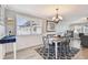The dining room has a decorative chandelier and gray accent furniture on the gray and white rug at 5960 30Th S Ave # 414, Gulfport, FL 33707