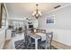 Dining room with chandelier, art, and workspace open to the living area at 5960 30Th S Ave # 414, Gulfport, FL 33707