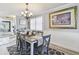 Dining area with wainscoting and light fixture is open to kitchen and living area at 5960 30Th S Ave # 414, Gulfport, FL 33707