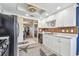 Bright kitchen boasts white cabinets, stainless steel appliances, and a charming starfish rug at 5960 30Th S Ave # 414, Gulfport, FL 33707
