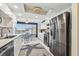 Bright kitchen features white cabinets, modern appliances, and dining area with water view at 5960 30Th S Ave # 414, Gulfport, FL 33707