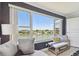 This home's living room features a bench and large windows overlooking the waterfront at 5960 30Th S Ave # 414, Gulfport, FL 33707