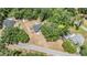 Aerial view of a serene property nestled among lush trees, showcasing its expansive land and surroundings at 6821 Mary Lou Ln, Wesley Chapel, FL 33544