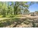 Large backyard with mature trees provides ample shade and space for outdoor activities and gatherings at 6821 Mary Lou Ln, Wesley Chapel, FL 33544