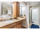 Elegant bathroom with granite countertops, and a glass-enclosed shower, blending functionality with style at 6821 Mary Lou Ln, Wesley Chapel, FL 33544