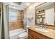 Cozy bathroom with bathtub, shower, and vanity, combining comfort and functionality at 6821 Mary Lou Ln, Wesley Chapel, FL 33544