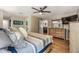Comfortable bedroom with wood floors, ceiling fan, dresser, and ample natural light, creating a cozy retreat at 6821 Mary Lou Ln, Wesley Chapel, FL 33544