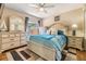 Bedroom with a ceiling fan, dresser, and large windows, creating a bright and airy retreat at 6821 Mary Lou Ln, Wesley Chapel, FL 33544
