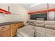 Bonus room features a cozy sectional and custom cabinetry at 6821 Mary Lou Ln, Wesley Chapel, FL 33544