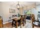 Cozy dining area with a wooden table, chandelier, and a view of the outdoors at 6821 Mary Lou Ln, Wesley Chapel, FL 33544