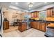 Well-lit kitchen showcasing custom cabinetry, granite countertops, stainless steel appliances, and tile flooring at 6821 Mary Lou Ln, Wesley Chapel, FL 33544