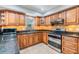 Well-lit kitchen showcasing custom cabinetry, granite countertops, stainless steel appliances, and tile flooring at 6821 Mary Lou Ln, Wesley Chapel, FL 33544