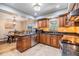 Well-lit kitchen showcasing custom cabinetry, granite countertops, stainless steel appliances, and tile flooring at 6821 Mary Lou Ln, Wesley Chapel, FL 33544