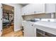 Efficient laundry room with white cabinets, washer, and dryer at 6821 Mary Lou Ln, Wesley Chapel, FL 33544