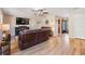 Comfortable living room with wood floors, mounted TV, and stylish decor, creating a warm and inviting atmosphere at 6821 Mary Lou Ln, Wesley Chapel, FL 33544