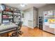 Well-lit office space with shelving, a desk, and a refrigerator at 6821 Mary Lou Ln, Wesley Chapel, FL 33544