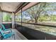 Relaxing screened patio with chairs and a view of the yard at 6821 Mary Lou Ln, Wesley Chapel, FL 33544