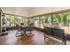 Enclosed patio featuring a dining area and lounge seating, perfect for outdoor entertaining and relaxation at 6821 Mary Lou Ln, Wesley Chapel, FL 33544